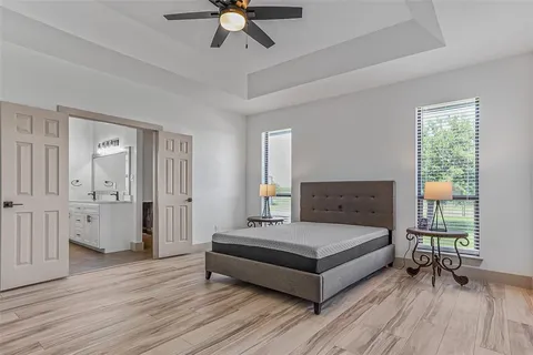 a bedroom with a bed and a chandelier