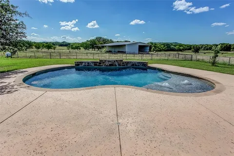a view of a swimming pool and a yard