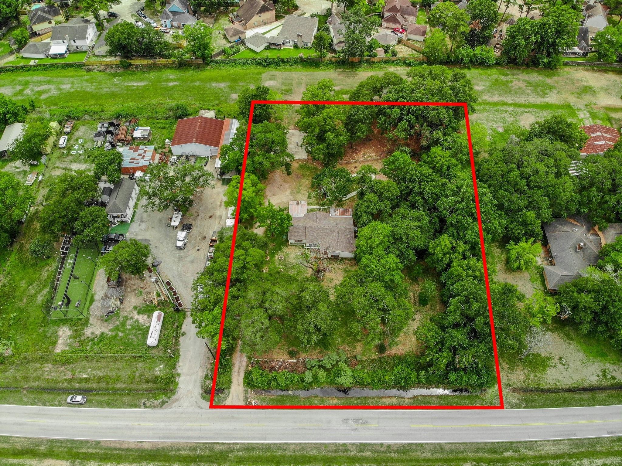 10005 Cypress North Houston Road Houston, TX 77070 - Photo 2 of 31 a view of a road with a yard and plants