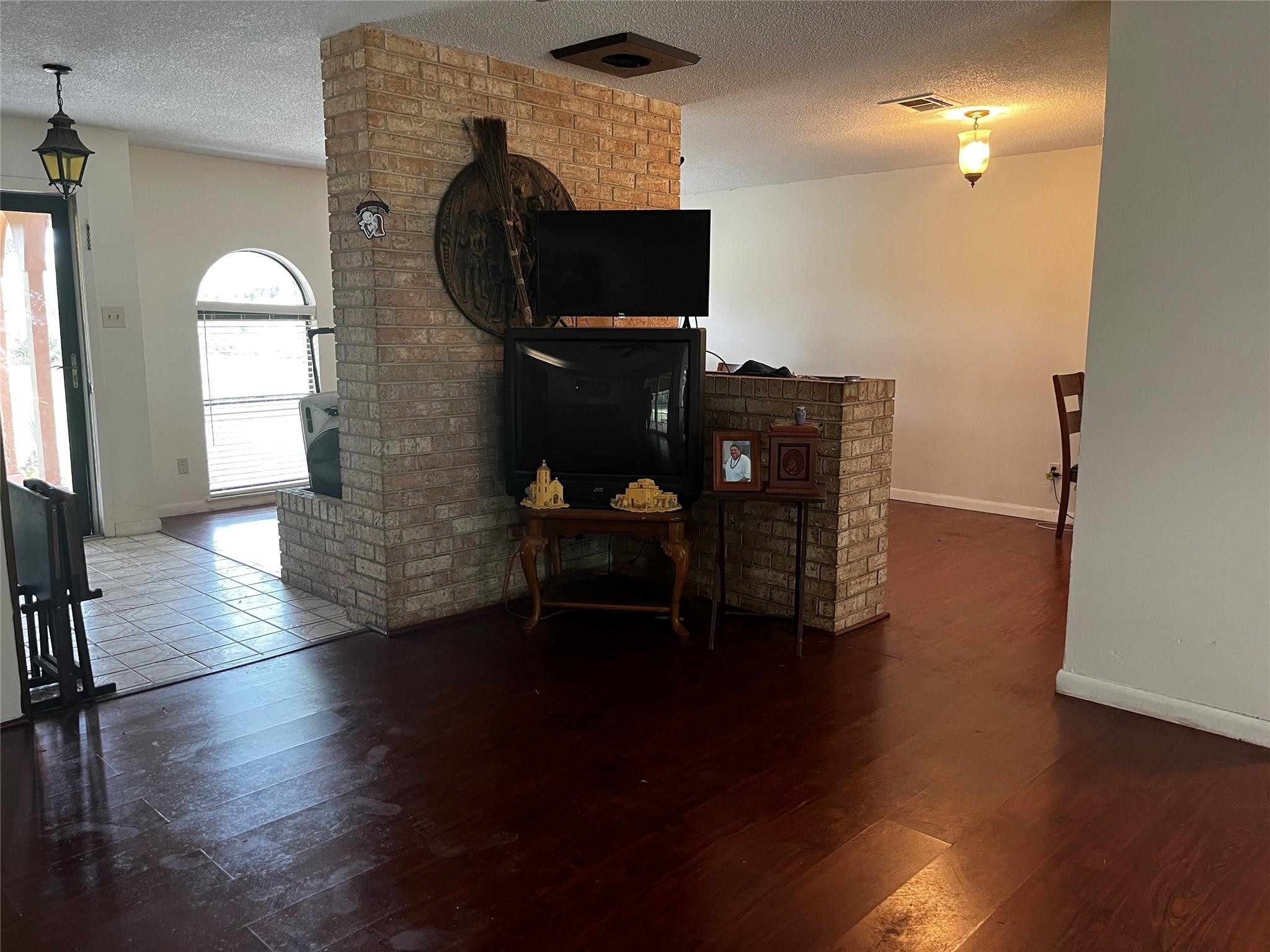 10005 Cypress North Houston Road Houston, TX 77070 - Photo 9 of 31 an empty room with wooden floor mirror and windows