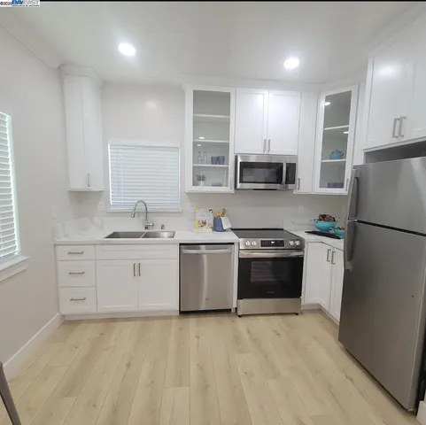 a kitchen with a stove a sink and a refrigerator