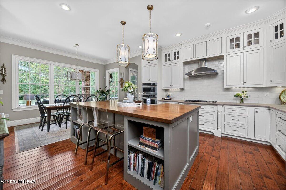106 Lagrange Place Macon, GA 31210 - Photo 13 of 76 a kitchen with granite countertop a stove a sink a center island and cabinets