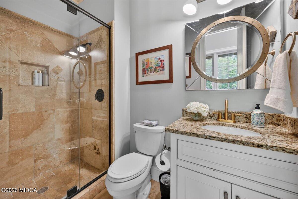 106 Lagrange Place Macon, GA 31210 - Photo 30 of 76 a bathroom with a granite countertop toilet a sink and a mirror