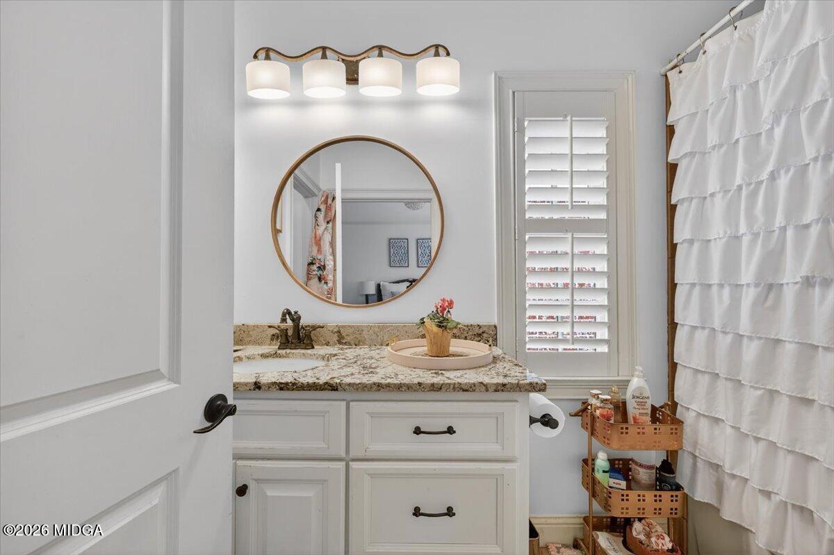 106 Lagrange Place Macon, GA 31210 - Photo 39 of 76 a bathroom with a granite countertop sink and a mirror