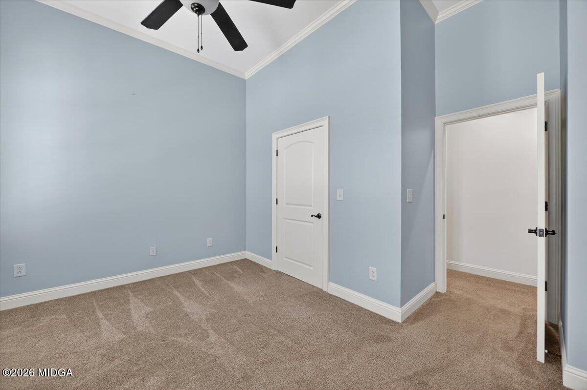 106 Lagrange Place Macon, GA 31210 - Photo 41 of 76 an empty room with a ceiling fan and carpet
