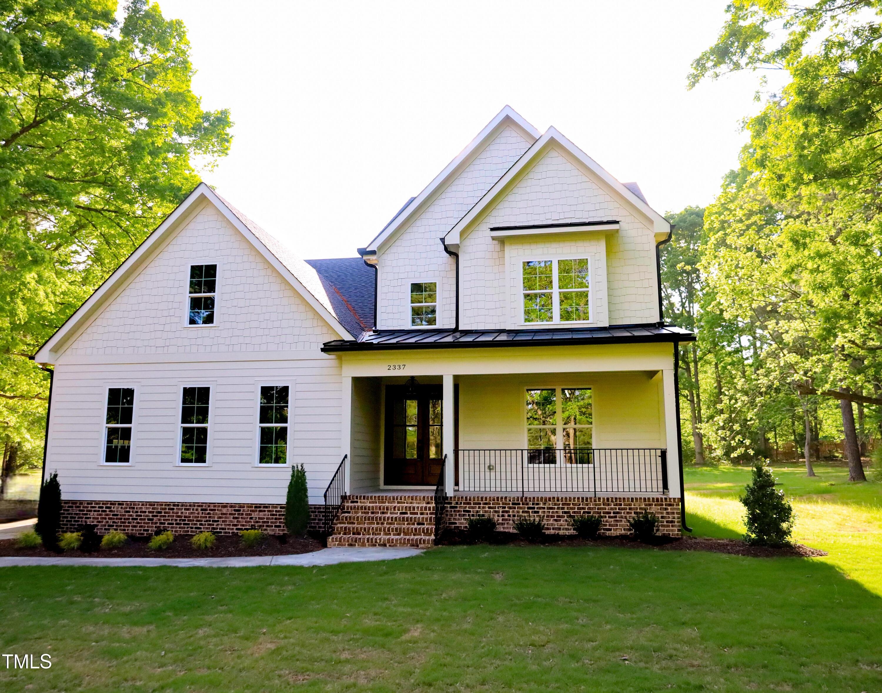 2337 Pearces Road Zebulon, NC 27597 - Photo 1 of 41 a front view of a house with a yard and garage