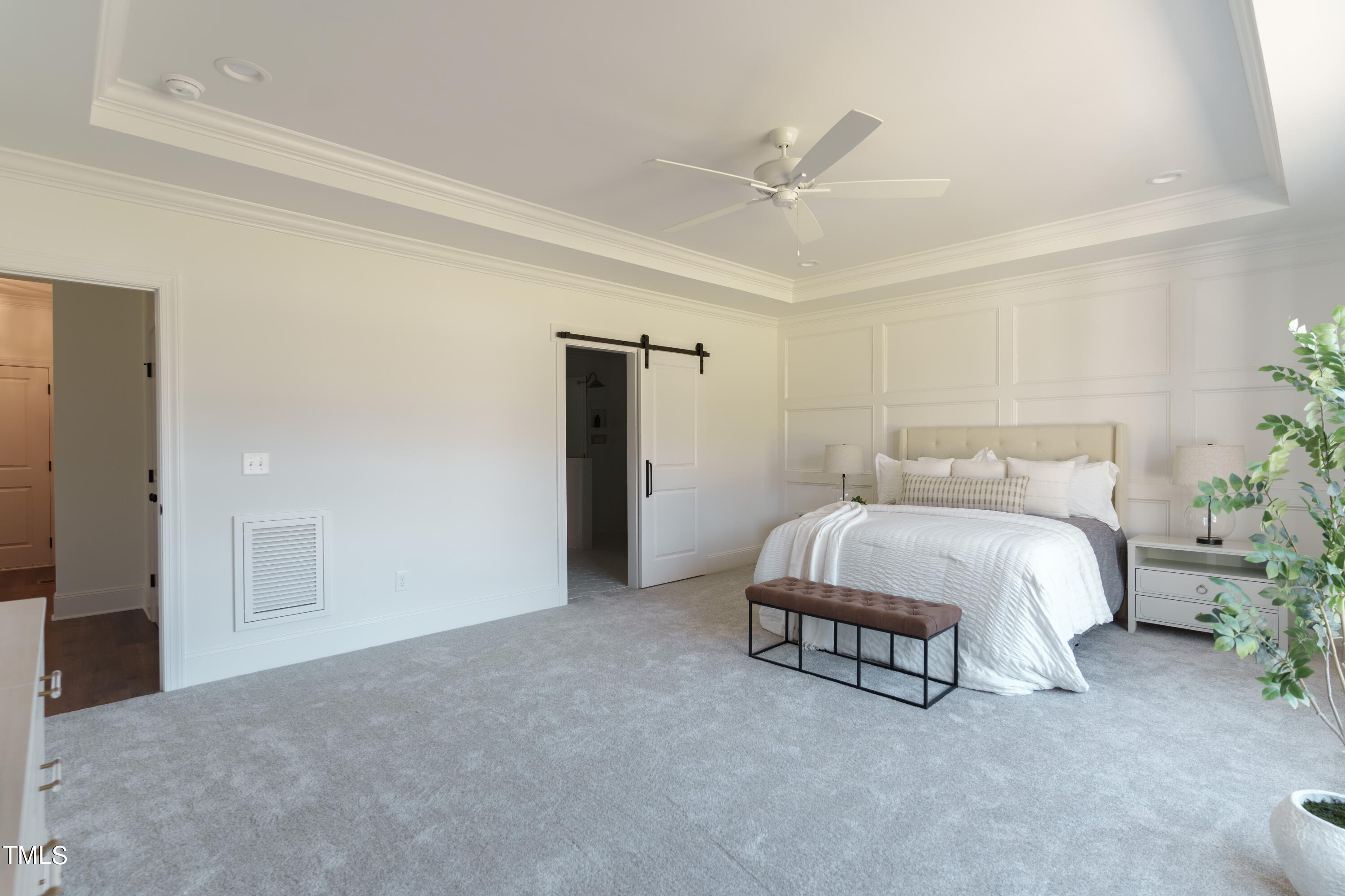 2337 Pearces Road Zebulon, NC 27597 - Photo 25 of 41 a spacious bedroom with a bed and a potted plant