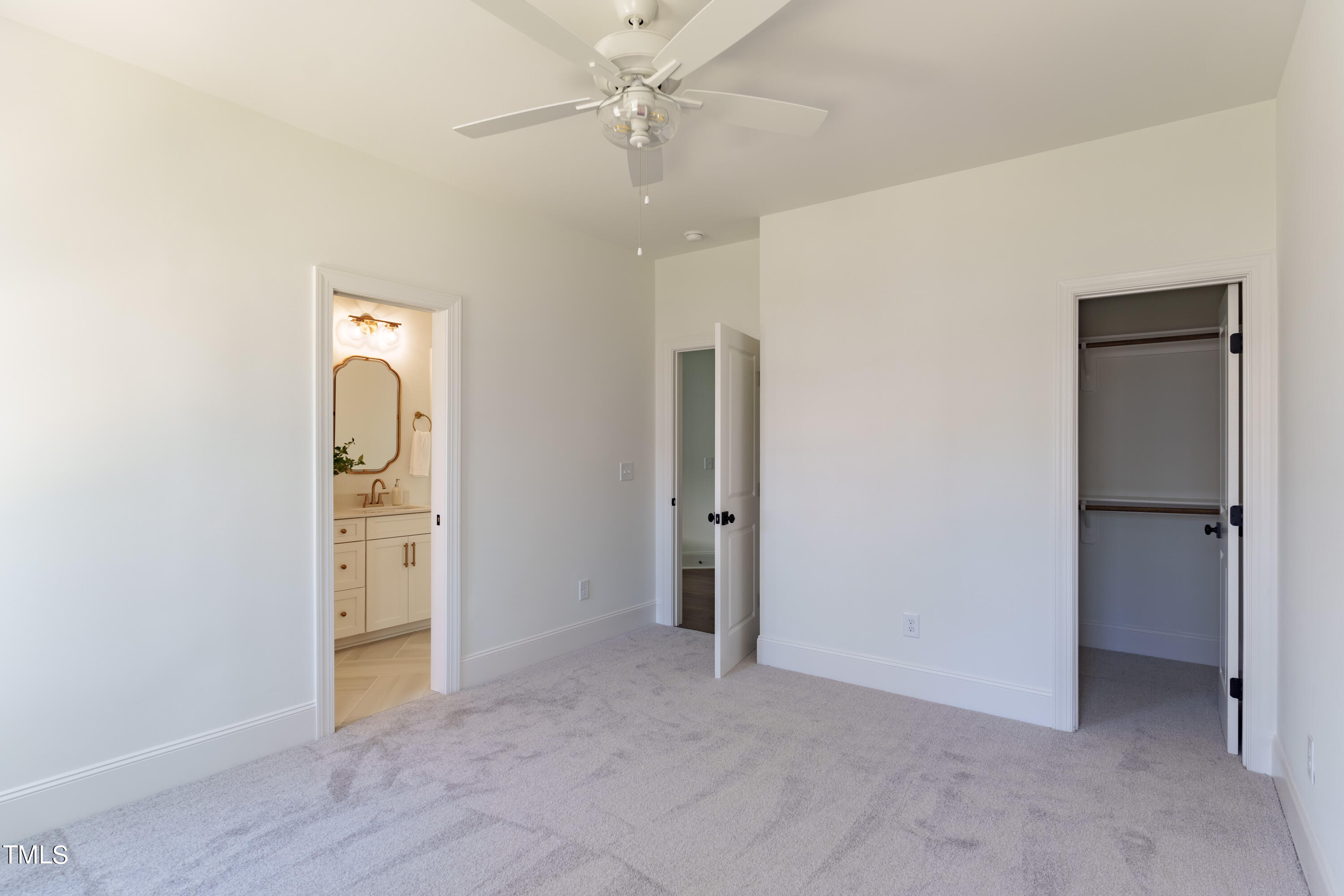 2337 Pearces Road Zebulon, NC 27597 - Photo 33 of 41 an empty room with closet and a chandelier fan