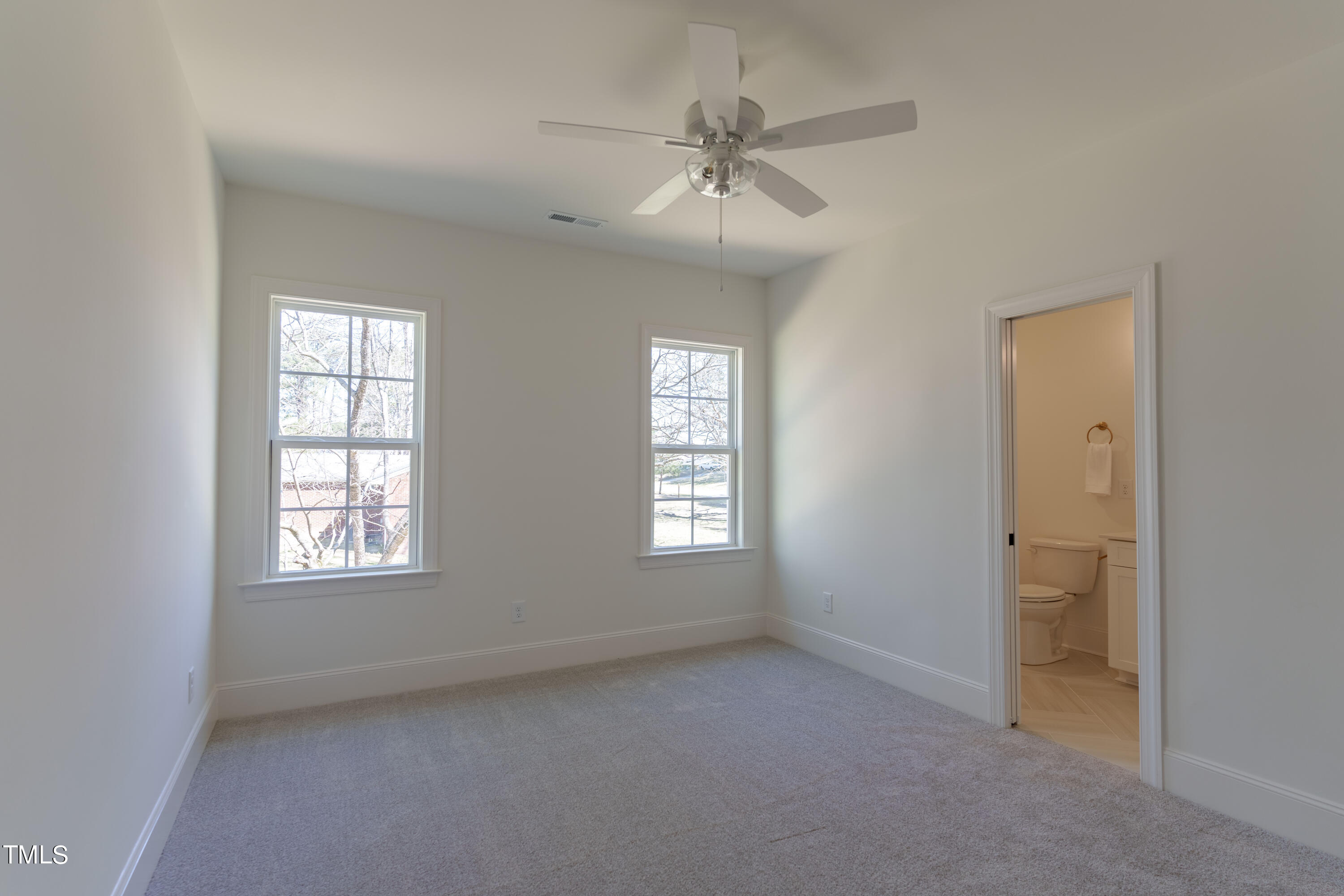 2337 Pearces Road Zebulon, NC 27597 - Photo 34 of 41 an empty room with windows and fan