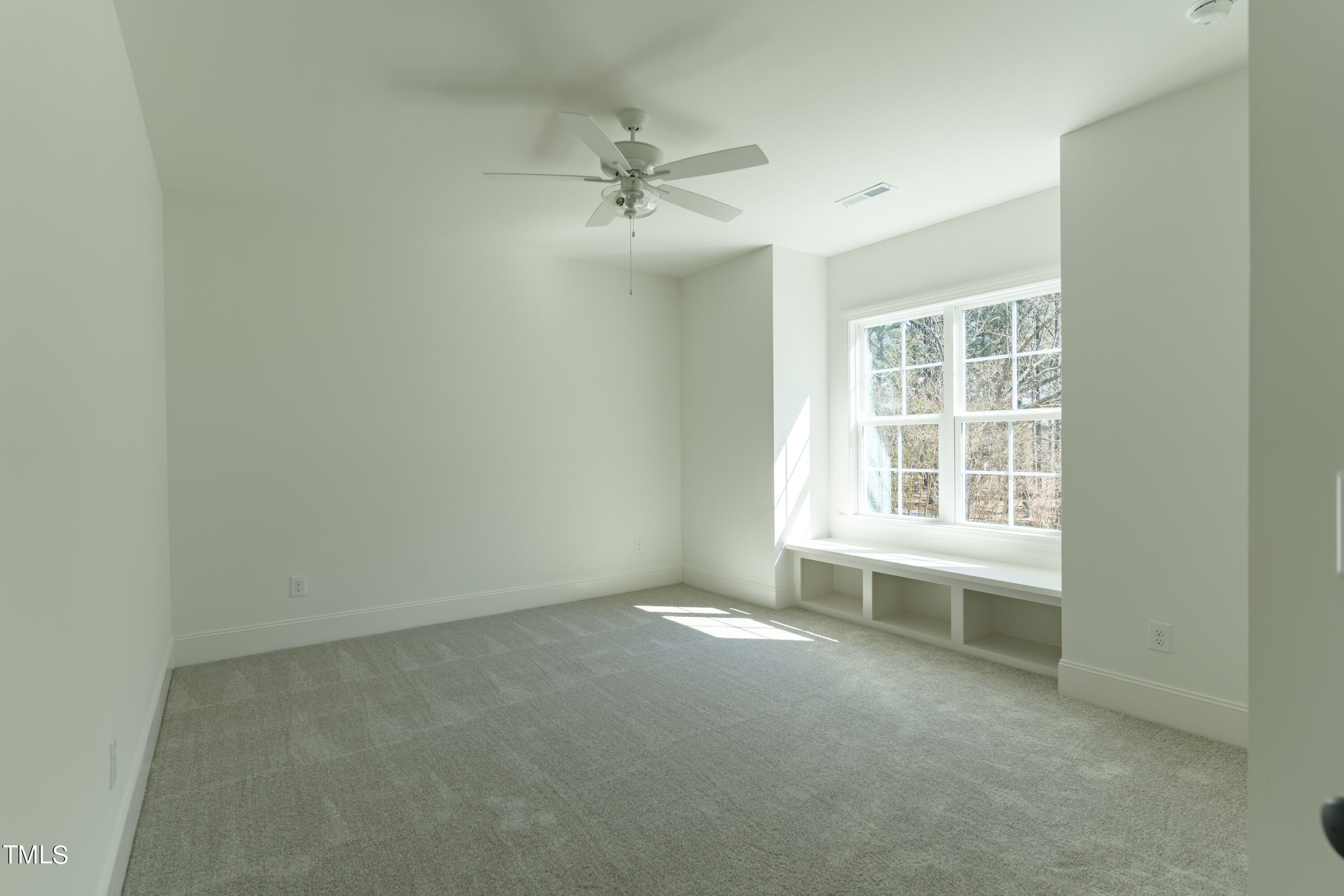 2337 Pearces Road Zebulon, NC 27597 - Photo 40 of 41 an empty room with windows and fan