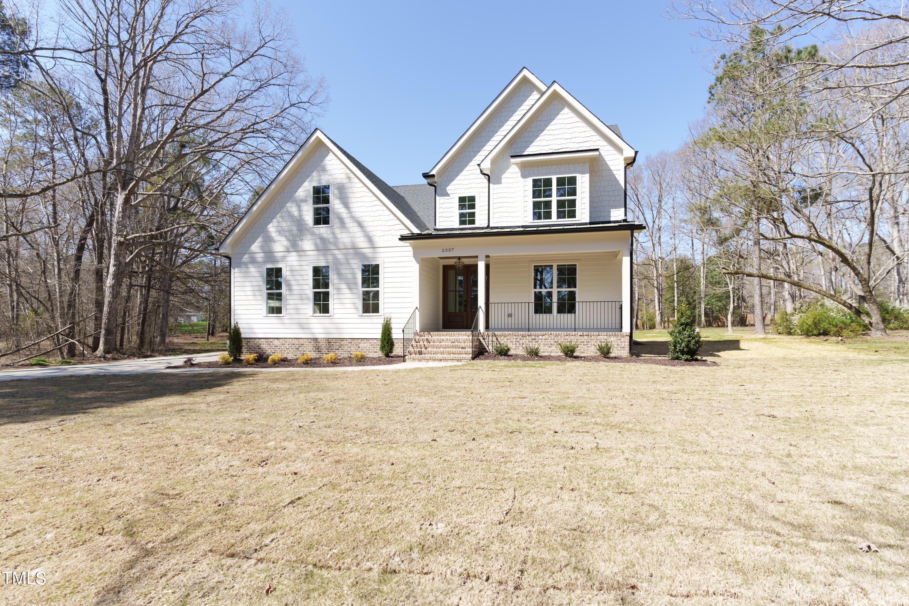 2337 Pearces Road Zebulon, NC 27597 - Photo 5 of 41 a front view of a house with a yard covered in snow