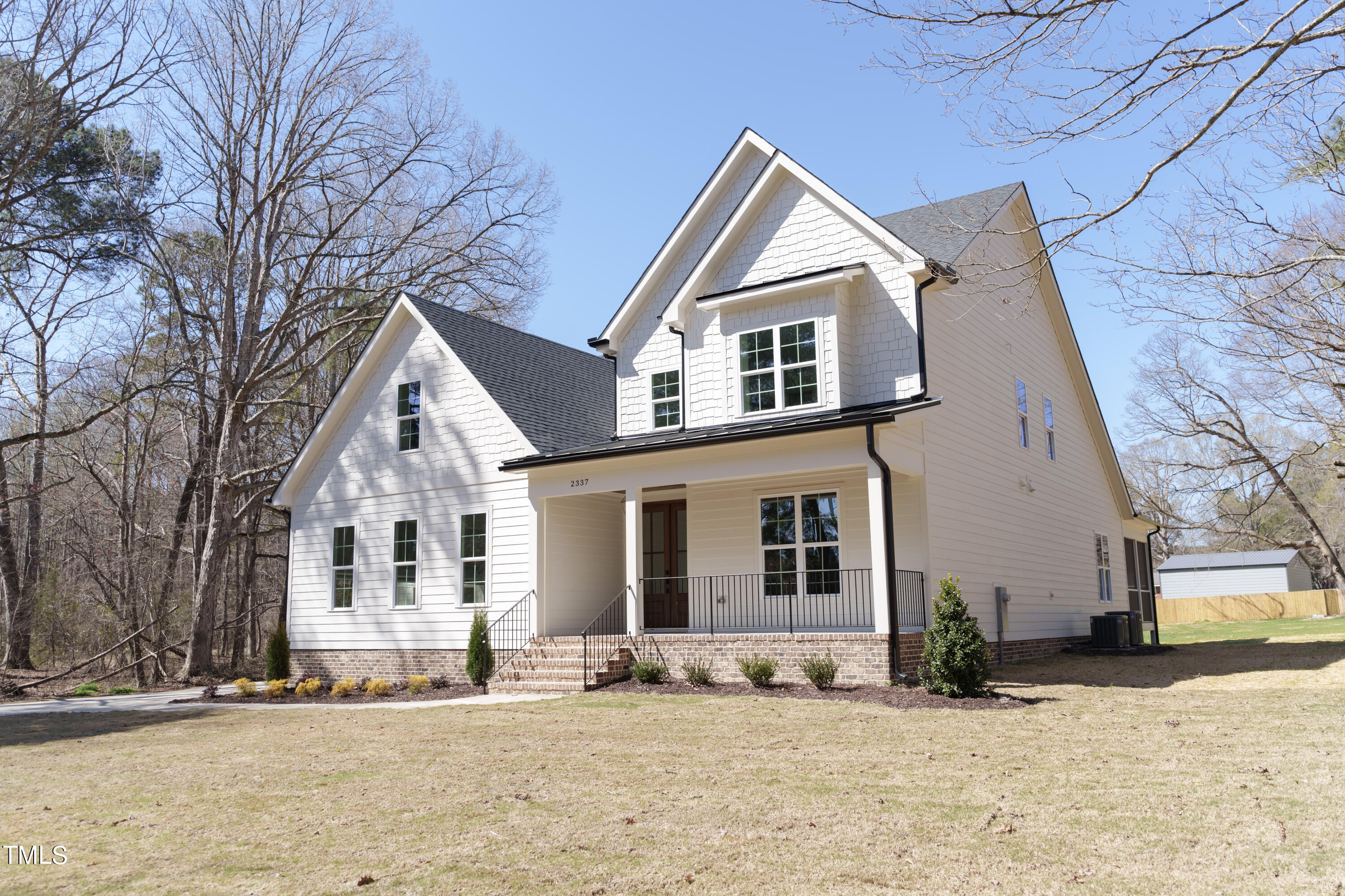 2337 Pearces Road Zebulon, NC 27597 - Photo 6 of 41 a front view of a house with a yard