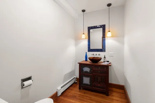 a room with a mirror and a wooden floor