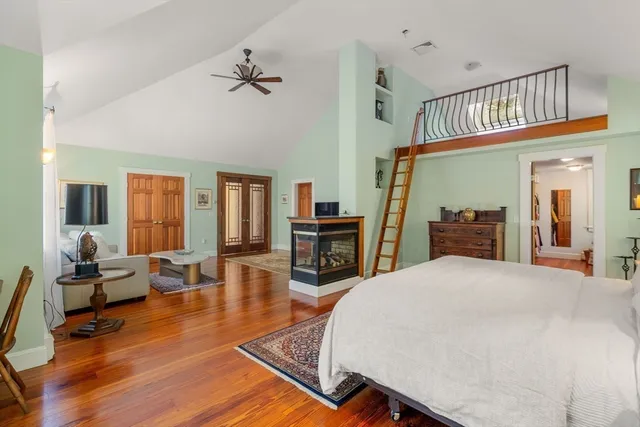 a living room with furniture a piano and a chandelier