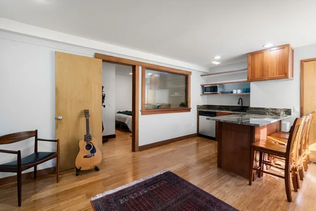 a living room with furniture and a kitchen view