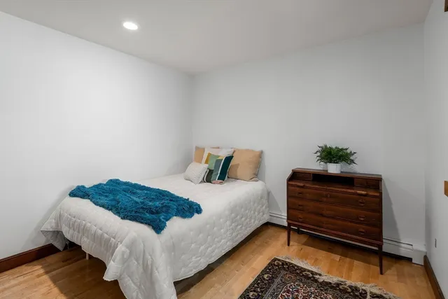 a bedroom with a bed and a dresser