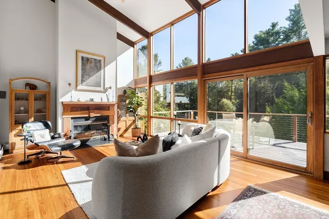 a living room with furniture and floor to ceiling windows