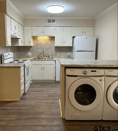 a kitchen with stainless steel appliances granite countertop a sink and cabinets