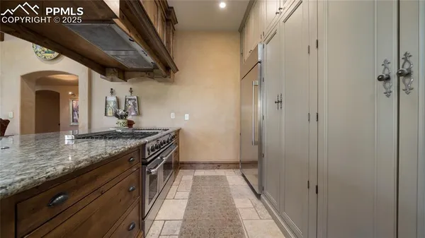 a spacious bathroom with a granite countertop sink and a mirror