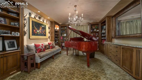 a living room with furniture a dining table and a chandelier