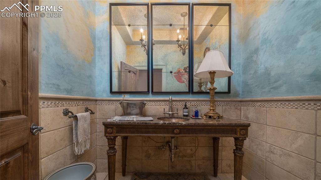 4896 Stonehill Road Colorado Springs, CO 80918 - Photo 15 of 42 a bathroom with a sink and a mirror