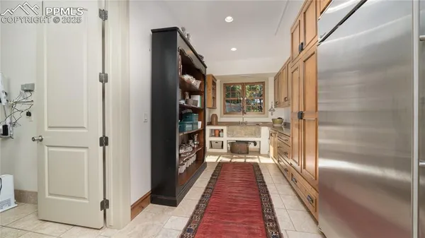 a hallway view with wooden floor and electronic appliances