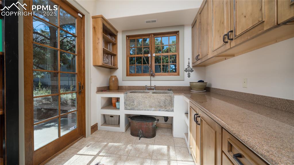4896 Stonehill Road Colorado Springs, CO 80918 - Photo 17 of 42 a kitchen with stainless steel appliances granite countertop a sink and a stove