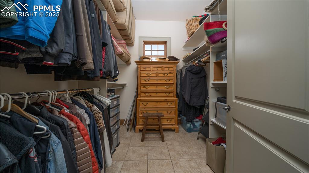 4896 Stonehill Road Colorado Springs, CO 80918 - Photo 18 of 42 a view of walk in closet with clothes and shoes