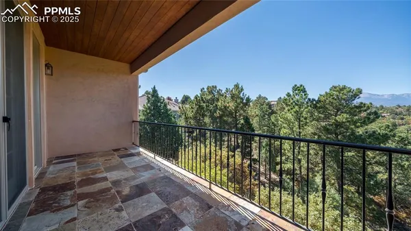 a balcony with trees in front of it