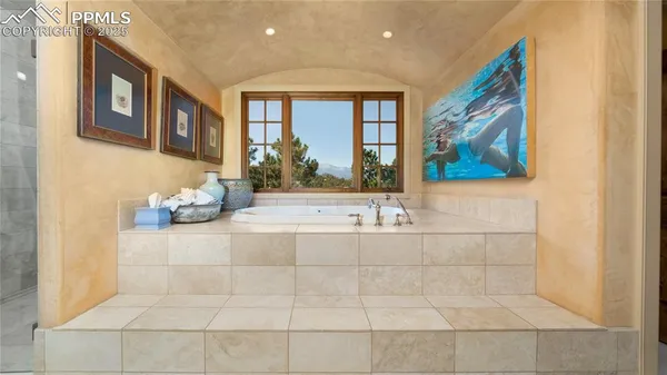 a view of a bathroom with a tub and shower
