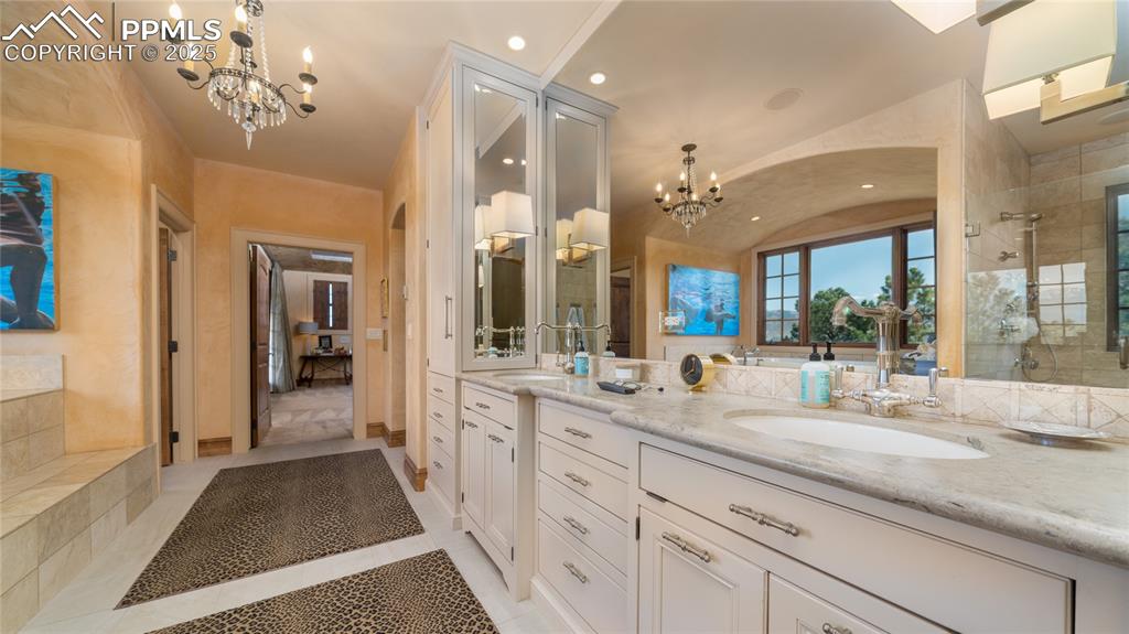 4896 Stonehill Road Colorado Springs, CO 80918 - Photo 25 of 42 a bathroom with a sink and a mirror