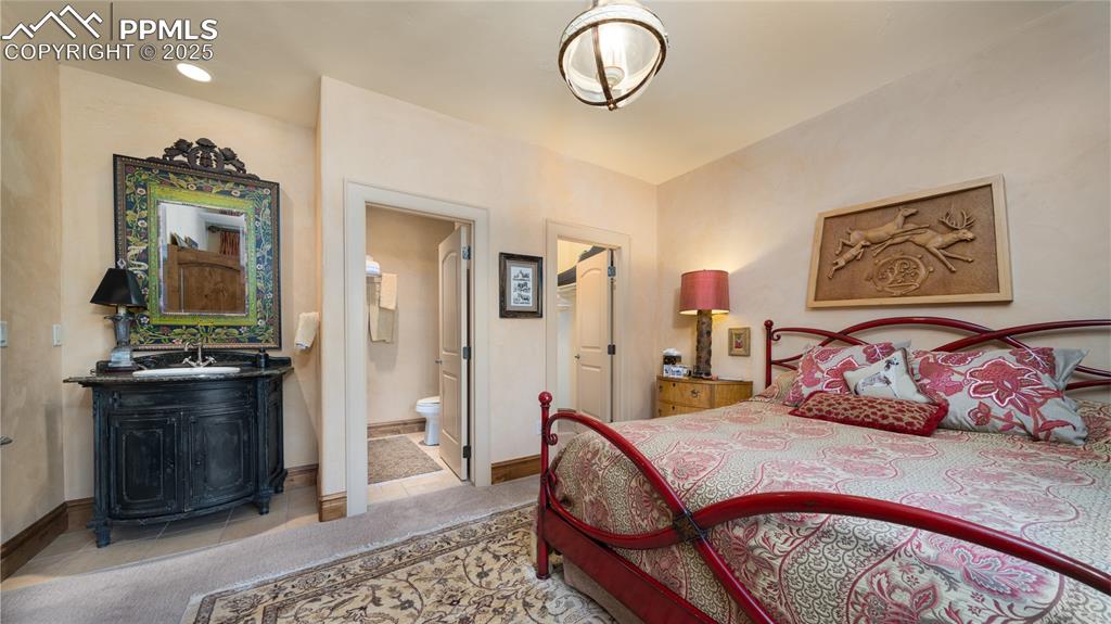 4896 Stonehill Road Colorado Springs, CO 80918 - Photo 27 of 42 a bedroom with a bed and wooden floor