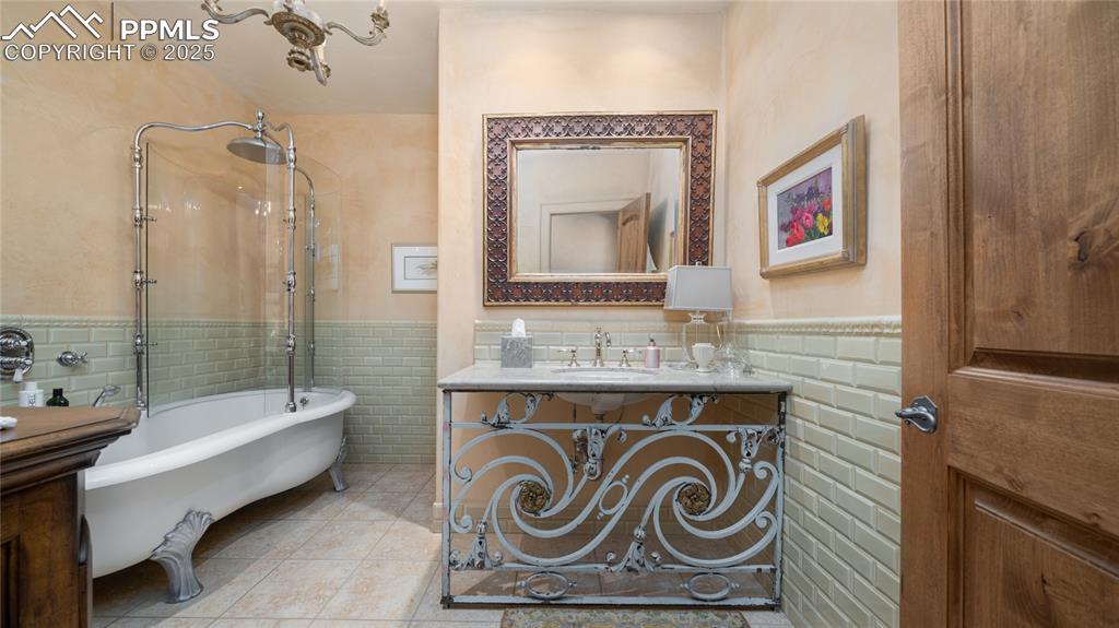 4896 Stonehill Road Colorado Springs, CO 80918 - Photo 29 of 42 a bathroom with a sink a mirror and a shower