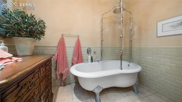 a bathroom with a bathtub and shower