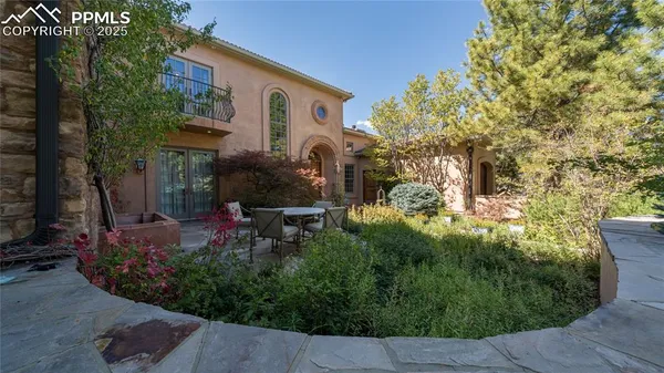 a view of a house with a backyard and sitting area