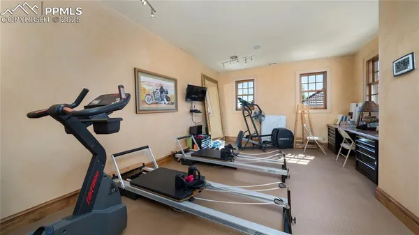 a room with gym equipment and a large window