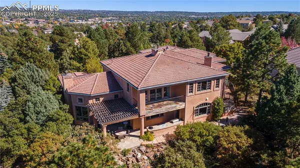 an aerial view of a house with a yard