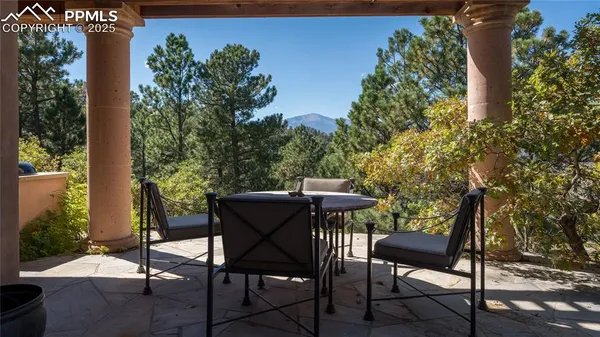 a view of a chairs and table in patio