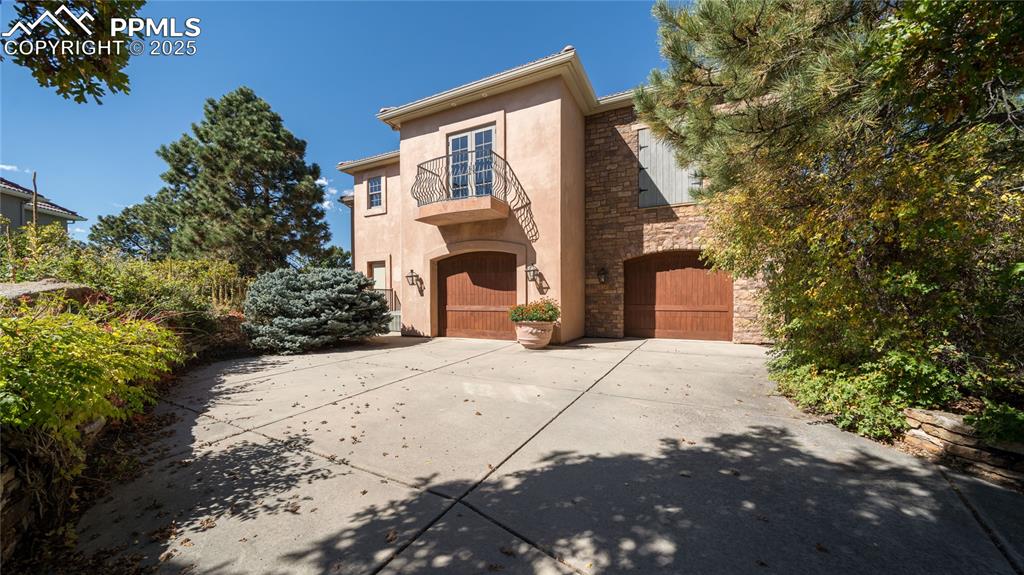 4896 Stonehill Road Colorado Springs, CO 80918 - Photo 39 of 42 a front view of a house with a yard and garage