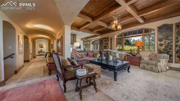 a living room with furniture and a chandelier