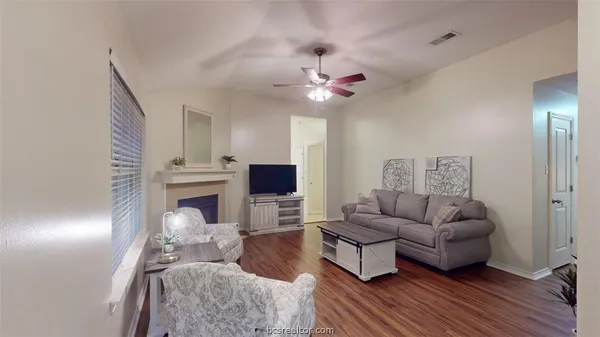 a living room with furniture and a fireplace