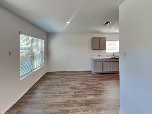 a view of kitchen with wooden floor and electronic appliances