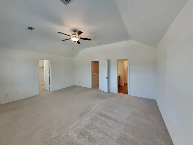 a view of a big room with ceiling fan and window