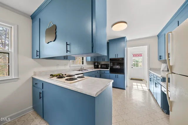 a kitchen with a sink cabinets and window