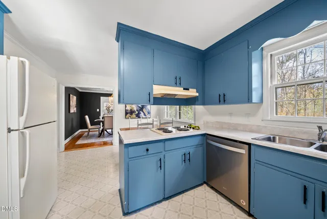 a kitchen with a stove a refrigerator and a sink