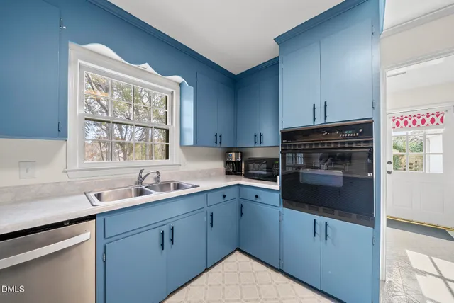 a kitchen with a sink stove and cabinets