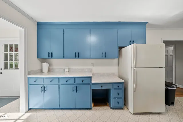 a kitchen with a sink a stove and cabinets