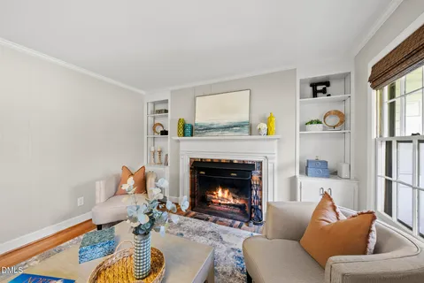 a living room with furniture a fireplace and a table