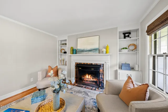 a living room with furniture a fireplace and a table