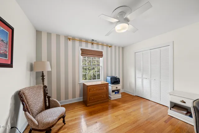 a spacious bedroom with a bed a window and a chandelier